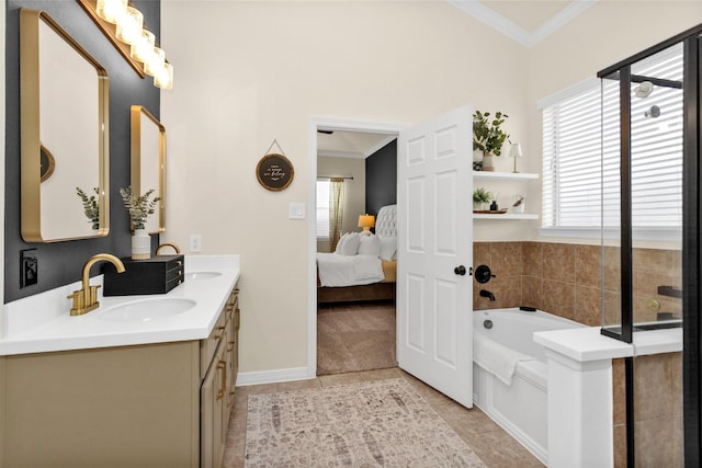 26642 Becker Pines Ln, Katy, TX 77494 - ensuite bathroom featuring ornamental molding, double vanity, healthy amount of natural light, a bath, and tile patterned floors