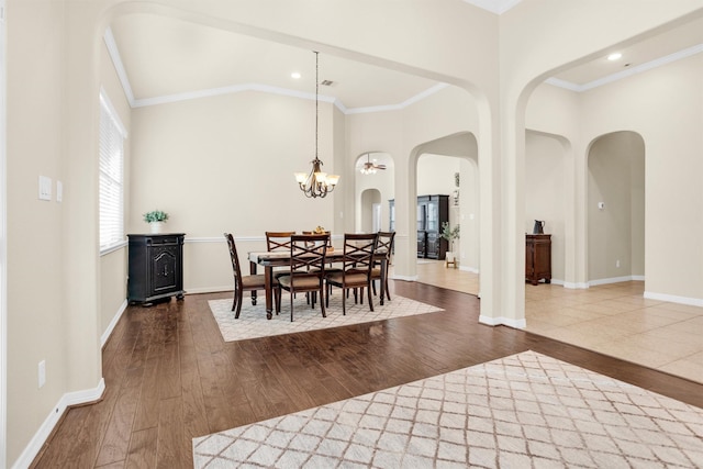 26642 Becker Pines Ln, Katy, TX 77494 - dining space featuring arched walkways, dark wood finished floors, crown molding, a chandelier, and high vaulted ceiling