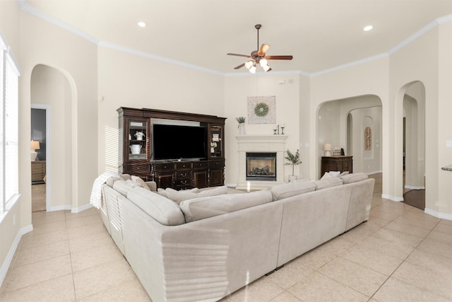 26642 Becker Pines Ln, Katy, TX 77494 - living area featuring arched walkways, light tile patterned floors, a ceiling fan, ornamental molding, and recessed lighting