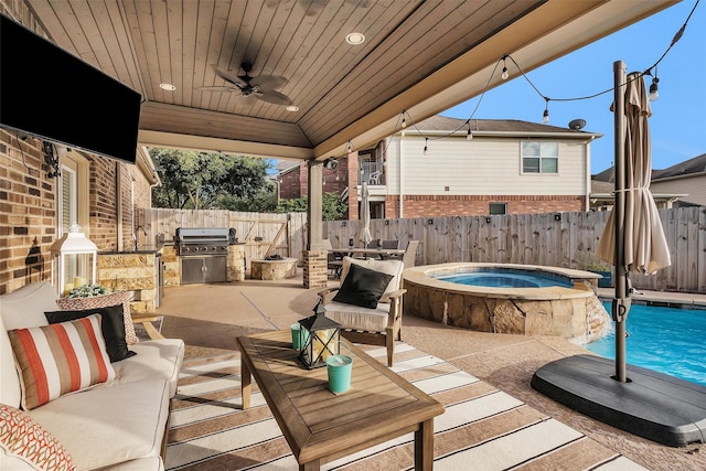 26642 Becker Pines Ln, Katy, TX 77494 - fenced backyard featuring ceiling fan, a patio, an outdoor hangout area, an outdoor kitchen, and a pool with connected hot tub