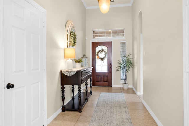 26642 Becker Pines Ln, Katy, TX 77494 - entryway featuring arched walkways, light tile patterned flooring, a towering ceiling, and crown molding