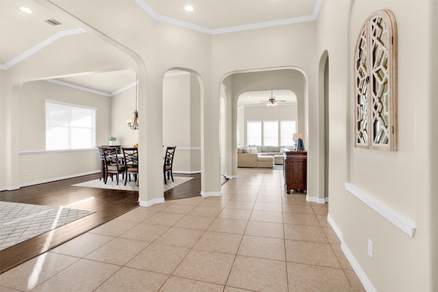 26642 Becker Pines Ln, Katy, TX 77494 - corridor with arched walkways, plenty of natural light, light tile patterned floors, recessed lighting, and crown molding