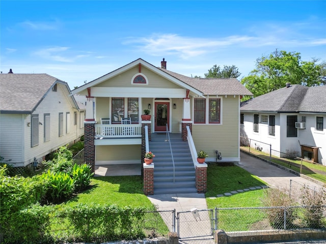 3815 Avenue N 1/2 Ave N 1/2, Galveston, TX 77550 - bungalow-style home with covered porch, a gate, stairway, a fenced front yard, and a chimney