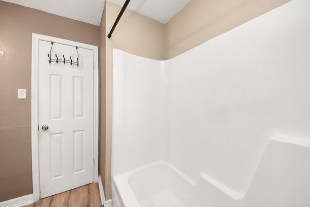 11877 Algonquin Dr, Houston, TX 77089 - bathroom with wood finished floors and washtub / shower combination