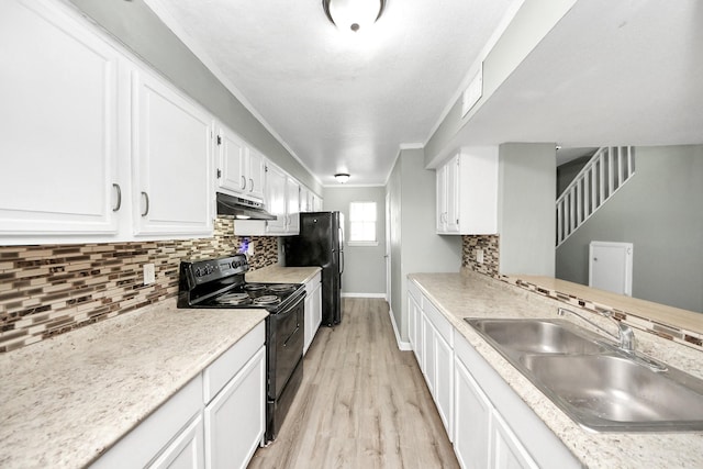 11877 Algonquin Dr, Houston, TX 77089 - kitchen featuring black appliances, under cabinet range hood, light wood-type flooring, white cabinets, and light countertops