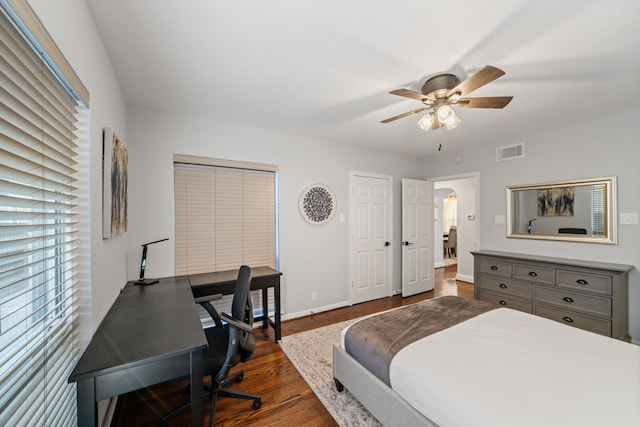 1926 Blodgett St, Houston, TX 77004 - bedroom with dark wood-type flooring, a desk, a ceiling fan, arched walkways, and multiple closets