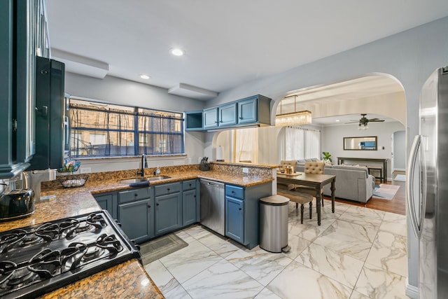 1926 Blodgett St, Houston, TX 77004 - kitchen featuring arched walkways, appliances with stainless steel finishes, ceiling fan, light marble finish flooring, and recessed lighting