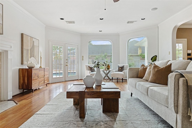1423 Meadow Lakes Dr, Sugar Land, TX 77479 - living room with arched walkways, crown molding, light wood-style floors, and recessed lighting