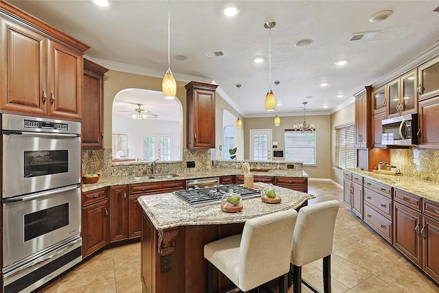 1423 Meadow Lakes Dr, Sugar Land, TX 77479 - kitchen with stainless steel appliances, a warming drawer, a center island, a breakfast bar, and ornamental molding