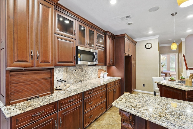 1423 Meadow Lakes Dr, Sugar Land, TX 77479 - kitchen with stainless steel microwave, ornamental molding, backsplash, light stone countertops, and pendant lighting