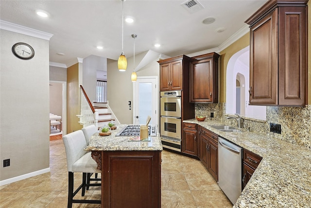 1423 Meadow Lakes Dr, Sugar Land, TX 77479 - kitchen featuring appliances with stainless steel finishes, backsplash, ornamental molding, arched walkways, and a center island