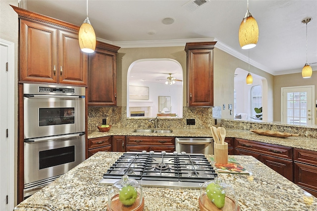 1423 Meadow Lakes Dr, Sugar Land, TX 77479 - kitchen featuring appliances with stainless steel finishes, arched walkways, pendant lighting, decorative backsplash, and crown molding