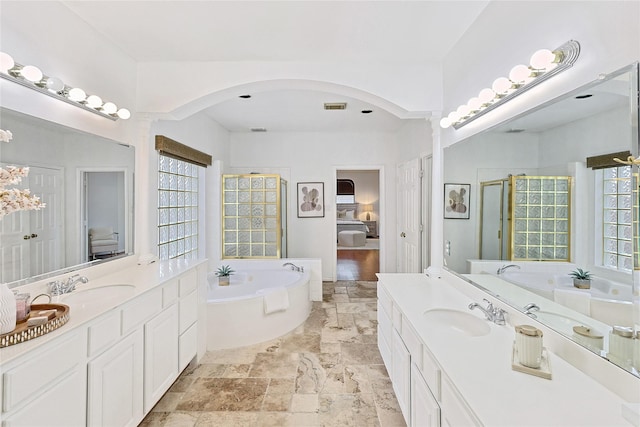 1423 Meadow Lakes Dr, Sugar Land, TX 77479 - full bath featuring a bath, two vanities, a stall shower, and stone tile flooring