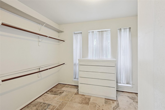 1423 Meadow Lakes Dr, Sugar Land, TX 77479 - walk in closet with stone tile floors