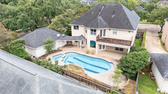 1423 Meadow Lakes Dr, Sugar Land, TX 77479 - view of swimming pool featuring french doors, a patio, a pool with connected hot tub, and a fenced backyard