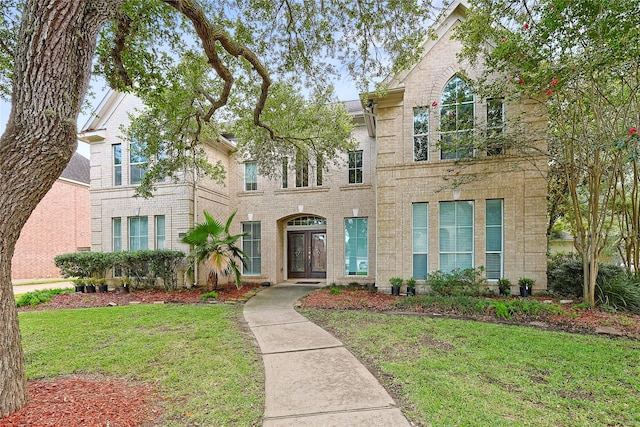 1423 Meadow Lakes Dr, Sugar Land, TX 77479 - view of front of house featuring brick siding, a front yard, and french doors