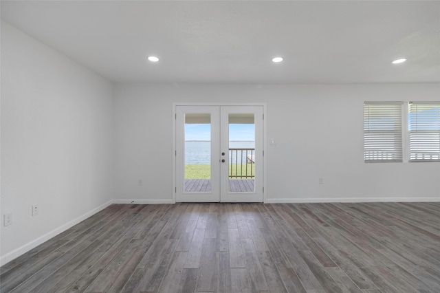 810 W Cattle Dr, Onalaska, TX 77360 - empty room with french doors, plenty of natural light, wood finished floors, and recessed lighting