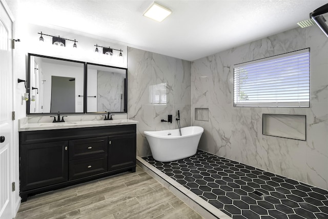 810 W Cattle Dr, Onalaska, TX 77360 - full bath featuring double vanity, a freestanding bath, and wood finish floors
