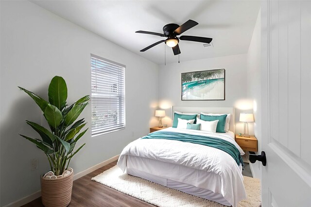 810 W Cattle Dr, Onalaska, TX 77360 - bedroom featuring wood finished floors and a ceiling fan