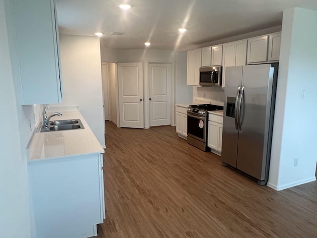 4127 Neches Bend Dr, Baytown, TX 77521 - kitchen featuring stainless steel appliances, wood finished floors, light countertops, white cabinets, and recessed lighting