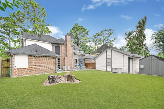 6710 Blue Hills Rd, Houston, TX 77069 - rear view of property with brick siding, a chimney, a storage shed, a shingled roof, and a patio area