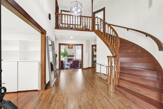 6710 Blue Hills Rd, Houston, TX 77069 - entryway with a high ceiling, wood finished floors, stairs, and a chandelier