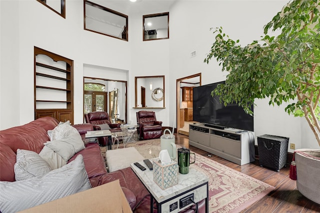 6710 Blue Hills Rd, Houston, TX 77069 - living area featuring wood-type flooring, a towering ceiling, and french doors
