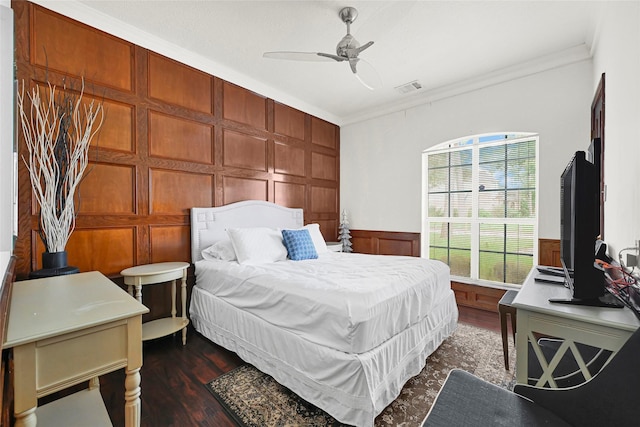 6710 Blue Hills Rd, Houston, TX 77069 - bedroom with crown molding, a decorative wall, dark wood-type flooring, a ceiling fan, and a wainscoted wall