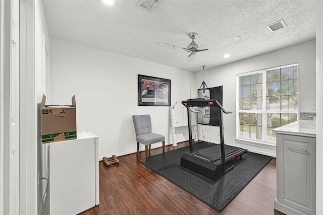 6710 Blue Hills Rd, Houston, TX 77069 - workout room featuring ceiling fan, dark wood-style floors, recessed lighting, and a textured ceiling