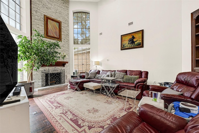 6710 Blue Hills Rd, Houston, TX 77069 - living room with healthy amount of natural light, a high ceiling, dark wood-style flooring, and a fireplace