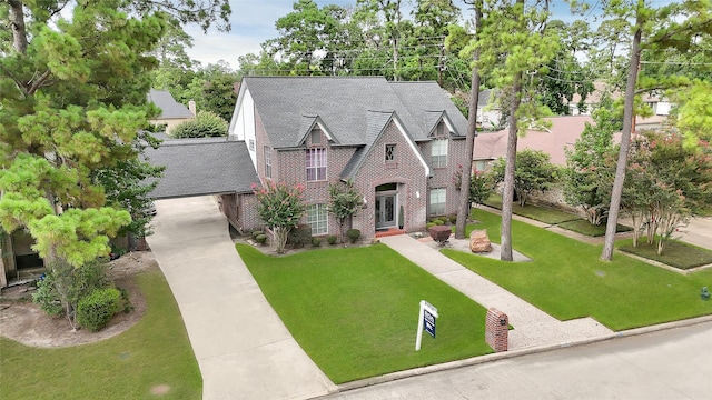 6710 Blue Hills Rd, Houston, TX 77069 - english style home with brick siding, concrete driveway, a front lawn, and a shingled roof