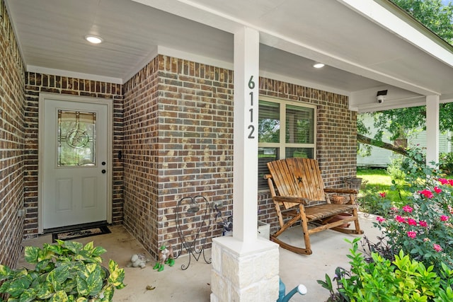 6112 Guyler St, Wallis, TX 77485 - view of exterior entry featuring brick siding and a porch