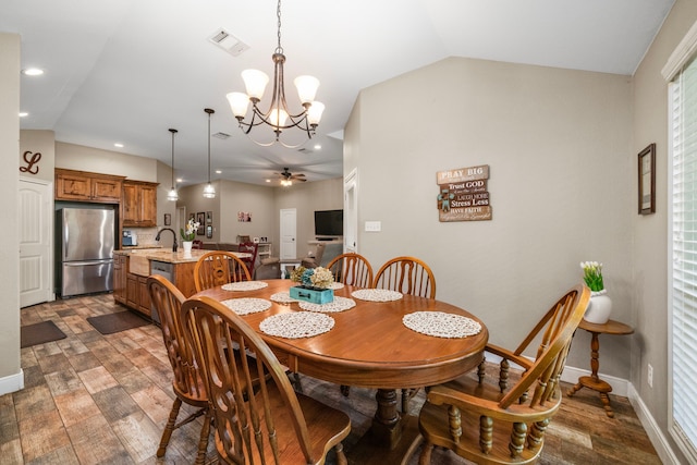 6112 Guyler St, Wallis, TX 77485 - dining area with wood finished floors, vaulted ceiling, a chandelier, ceiling fan, and recessed lighting
