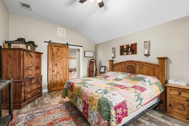 6112 Guyler St, Wallis, TX 77485 - bedroom featuring a barn door, lofted ceiling, light wood-type flooring, and ceiling fan