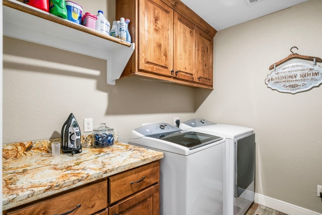 6112 Guyler St, Wallis, TX 77485 - laundry area with cabinet space, separate washer and dryer, and wood finished floors
