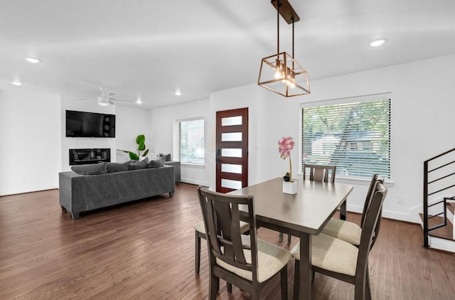 3021 Prospect St, Houston, TX 77004 - dining room with dark wood-type flooring, a ceiling fan, recessed lighting, a glass covered fireplace, and stairway