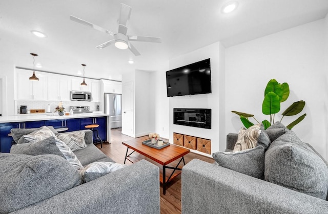 3021 Prospect St, Houston, TX 77004 - living area featuring wood finished floors, recessed lighting, and a ceiling fan