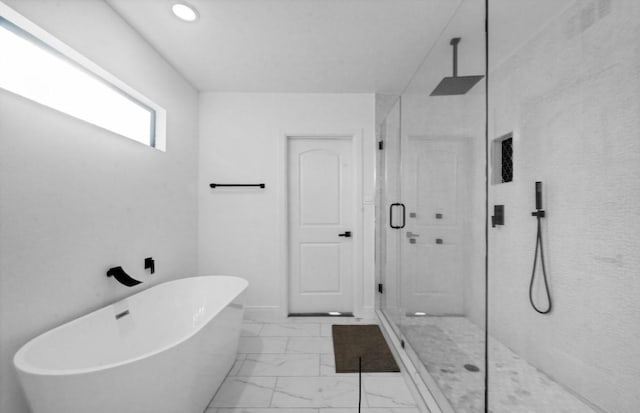 3021 Prospect St, Houston, TX 77004 - bathroom with a shower stall, marble finish floors, a freestanding tub, and recessed lighting