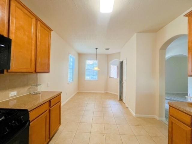 14706 Branchwest Dr, Houston, TX 77082 - kitchen featuring arched walkways, black appliances, and brown cabinetry