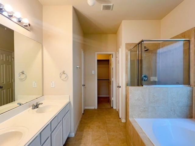 14706 Branchwest Dr, Houston, TX 77082 - bathroom with tile patterned floors, a shower stall, double vanity, and a bath