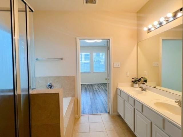 14706 Branchwest Dr, Houston, TX 77082 - bathroom with double vanity, a bath, tile patterned floors, and a shower with shower door