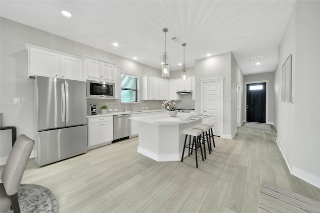 15122 Parkland Canyon Dr, Cypress, TX 77433 - kitchen featuring stainless steel appliances, white cabinetry, backsplash, a center island, and recessed lighting