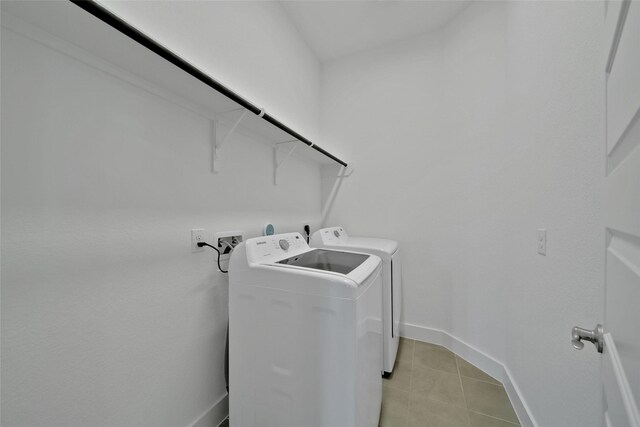 15122 Parkland Canyon Dr, Cypress, TX 77433 - laundry room with washer and dryer and light tile patterned floors