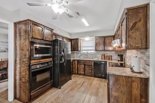 4957 Shadowbend Dr, Corpus Christi, TX 78413 - kitchen with black appliances, range hood, light wood-style flooring, decorative backsplash, and ceiling fan