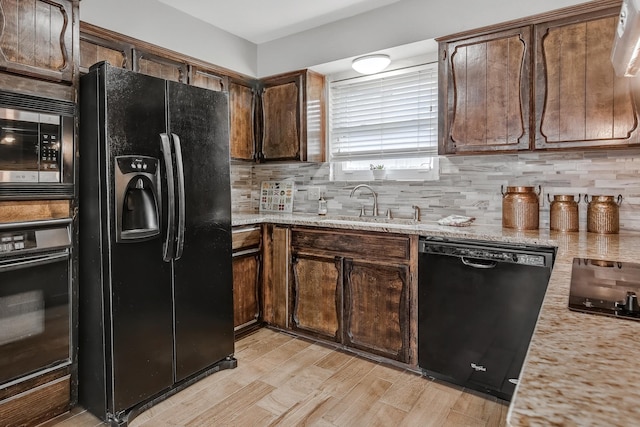 4957 Shadowbend Dr, Corpus Christi, TX 78413 - kitchen with black appliances, decorative backsplash, light wood-style floors, and dark brown cabinets