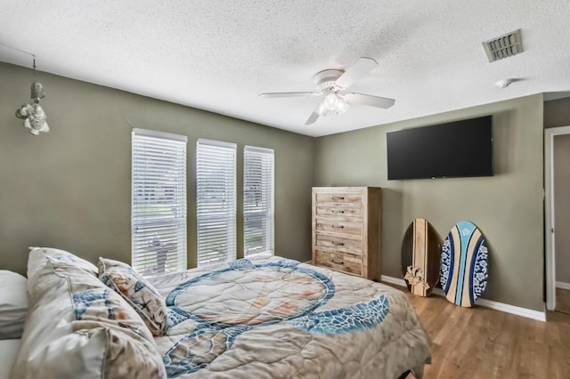 4957 Shadowbend Dr, Corpus Christi, TX 78413 - bedroom featuring wood finished floors, a textured ceiling, and ceiling fan