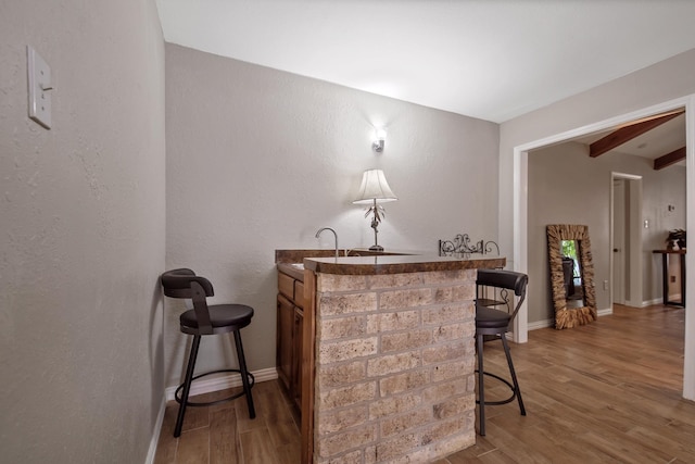 4957 Shadowbend Dr, Corpus Christi, TX 78413 - indoor bar with beam ceiling, light wood finished floors, and a textured wall