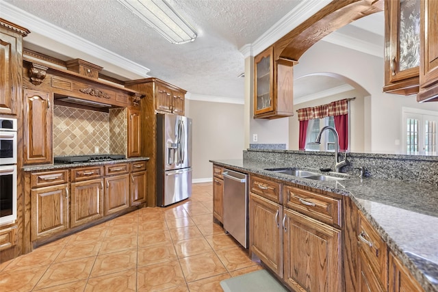 15908 Mcnorton, Splendora, TX 77372 - kitchen with stainless steel appliances, brown cabinetry, glass insert cabinets, tasteful backsplash, and crown molding