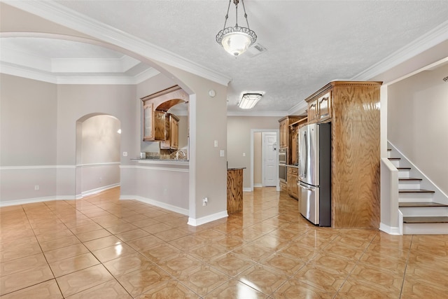 15908 Mcnorton, Splendora, TX 77372 - kitchen featuring stainless steel appliances, arched walkways, brown cabinets, light tile patterned floors, and a textured ceiling