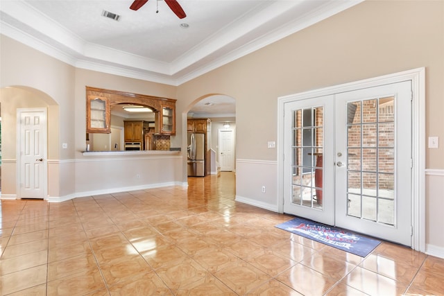 15908 Mcnorton, Splendora, TX 77372 - unfurnished living room featuring arched walkways, a ceiling fan, ornamental molding, light tile patterned floors, and french doors